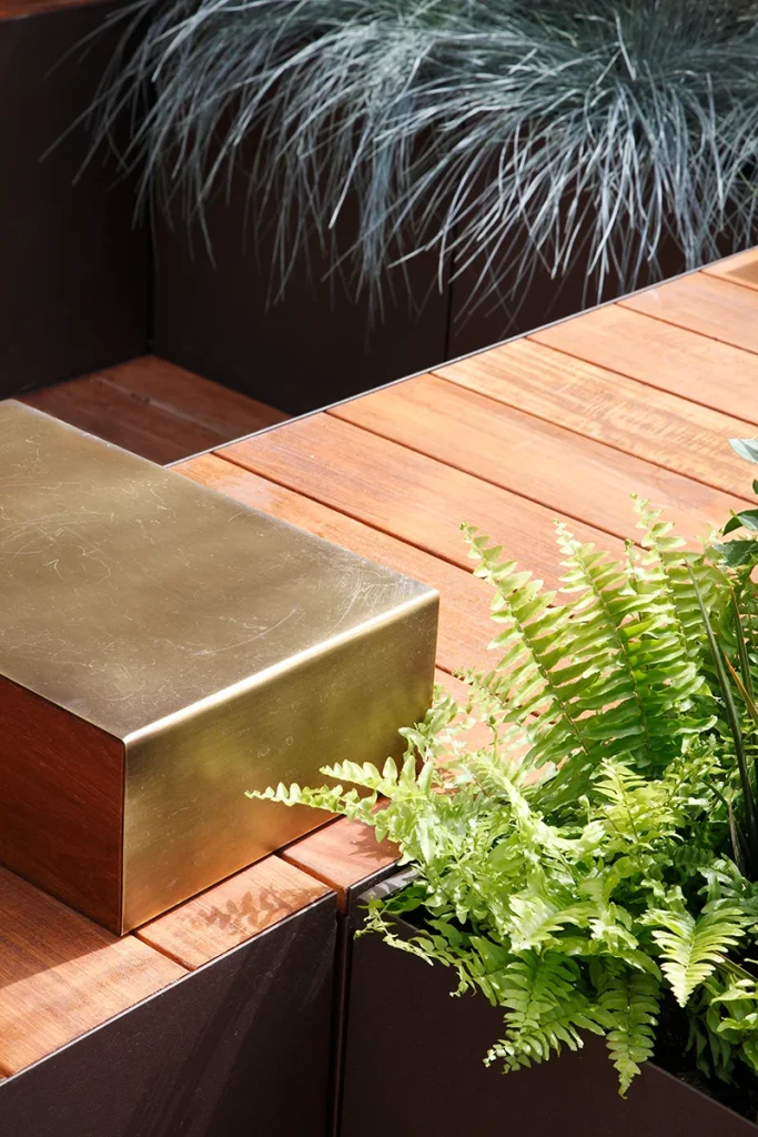 A gold box sits on top of a wooden deck.