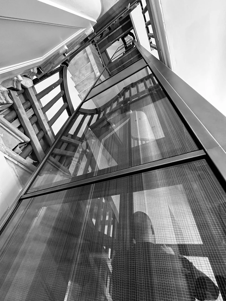 Lift shaft under construction with workman inside lift