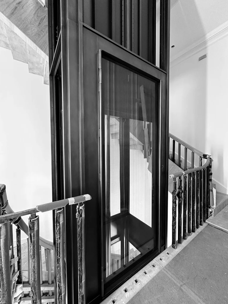 Black-and-white construction image showing lift shaft partway through installation