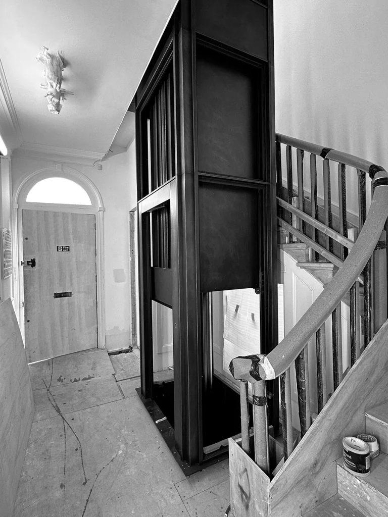 Entrance hallway landing with lift shaft and doors