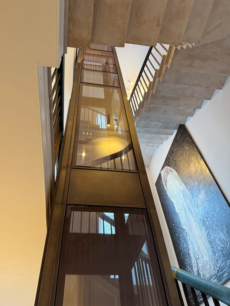 Final completed lift shaft glowing softly, viewed from the base of the staircase