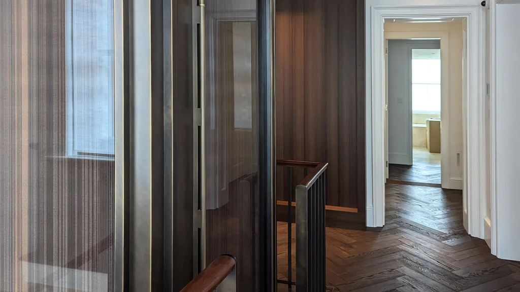 Interior view showing translucent vertical slats alongside lift, filtering daylight