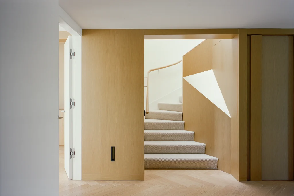 Wooden staircase with sculptural curved balustrade detail