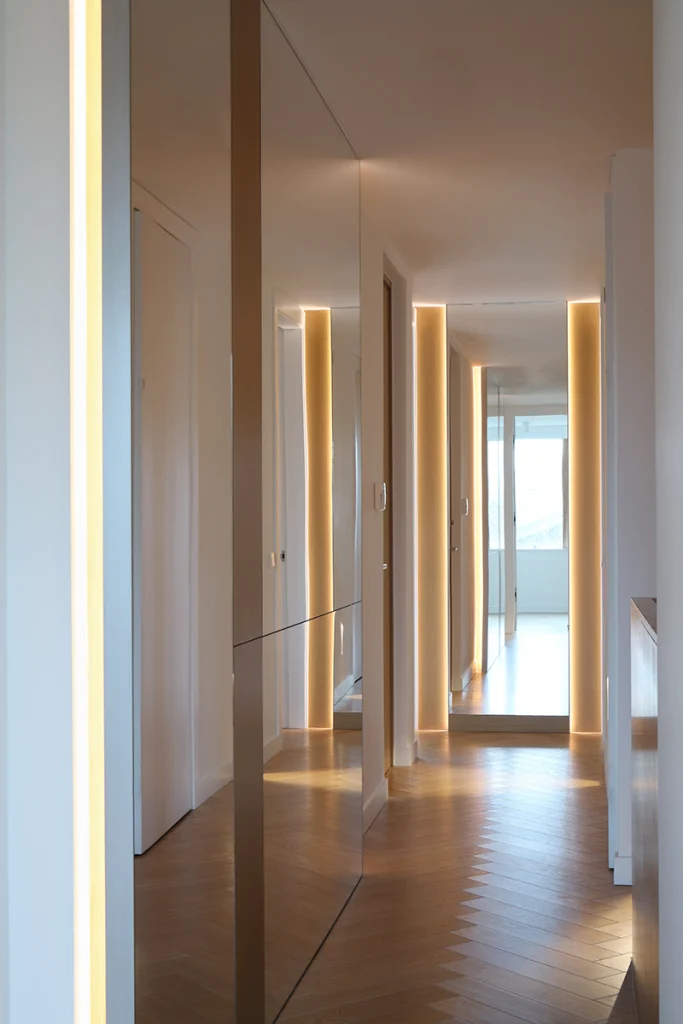 Long corridor with spotlighting and reflective panelling