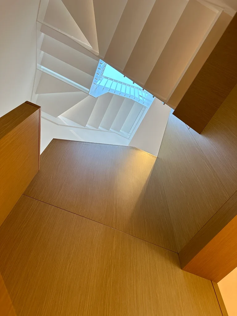 Central stairwell featuring wooden balustrade